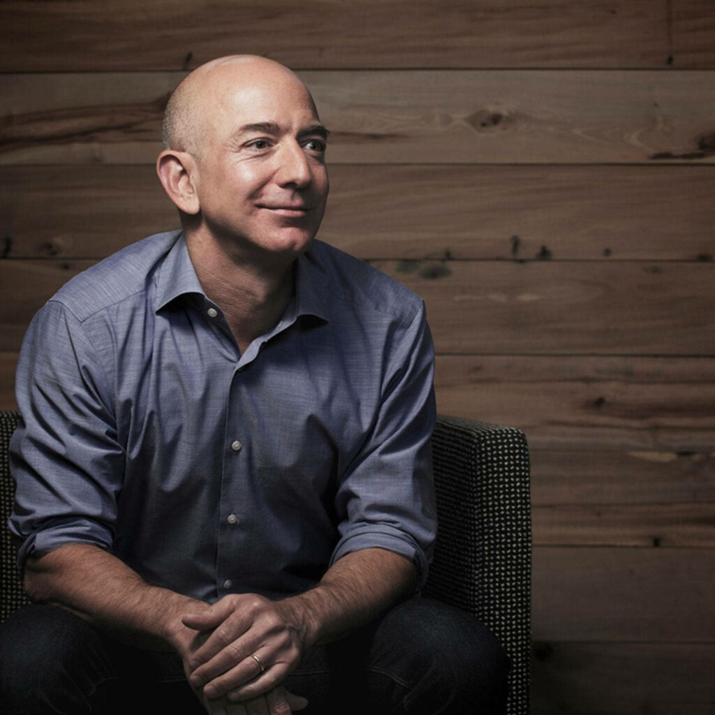 Jeff Bezos Relaxed Wallpaper: Calm Against Warm Wooden Background