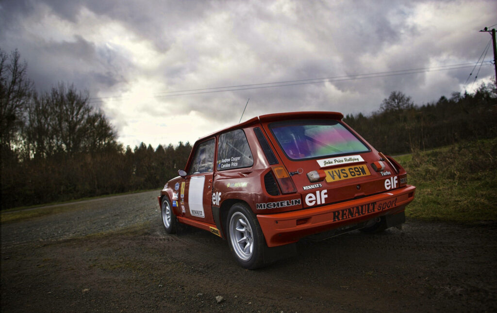 Renault 5 Turbo classic car on countryside road vintage rally racing under cloudy sky wallpaper