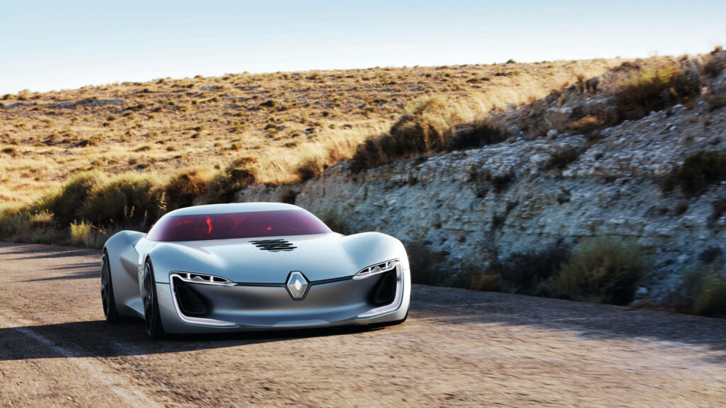 Renault Trezor concept car 4k wallpaper cruising scenic road with rugged terrain background