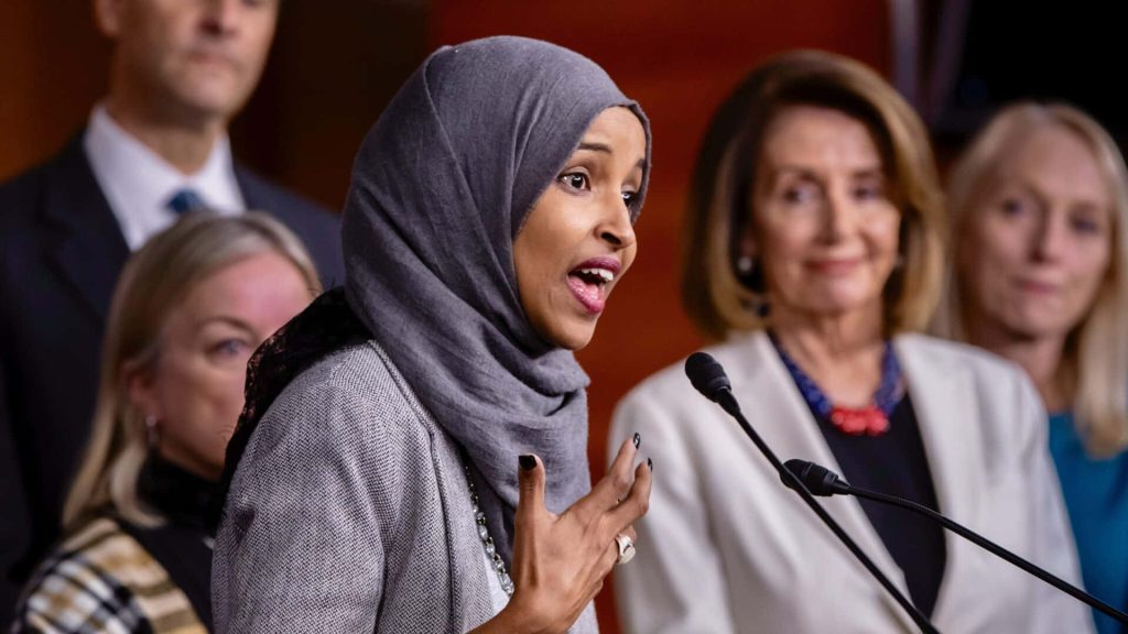 Representative Ilhan Omar speaks passionately at a political press conference with Nancy Pelosi present Wallpaper
