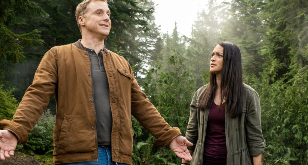 Resident Alien Wallpaper: Doctor & Assistant in Lush Forest Setting