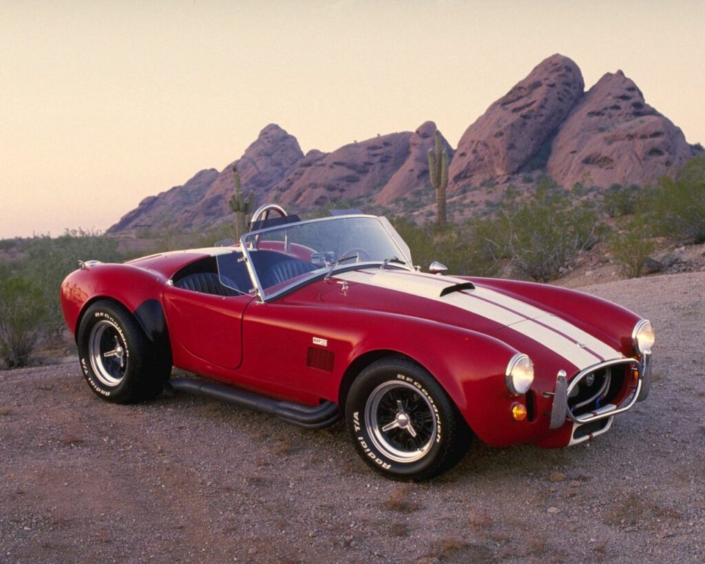 Retro 1962 AC Cobra Wallpaper: Classic Convertible in Desert Setting