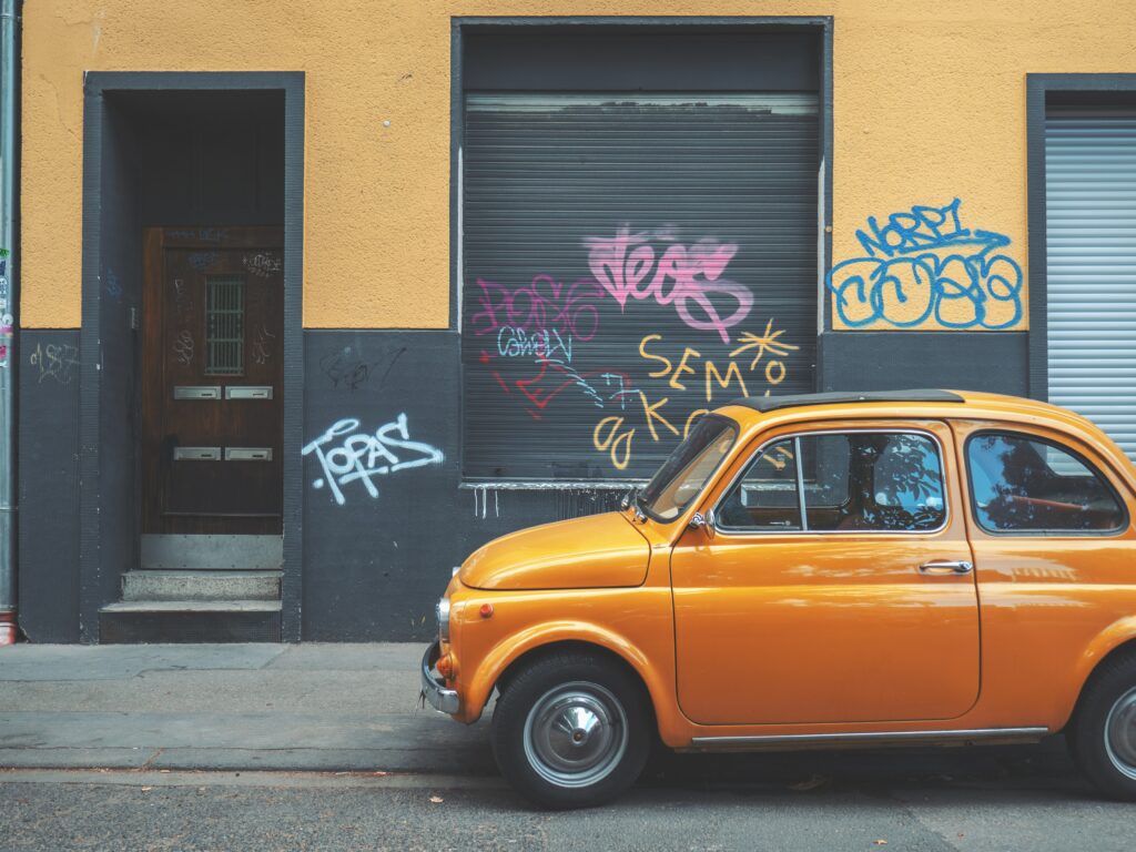 Retro Car Wallpaper: Classic Design Meets Vibrant Graffiti Art