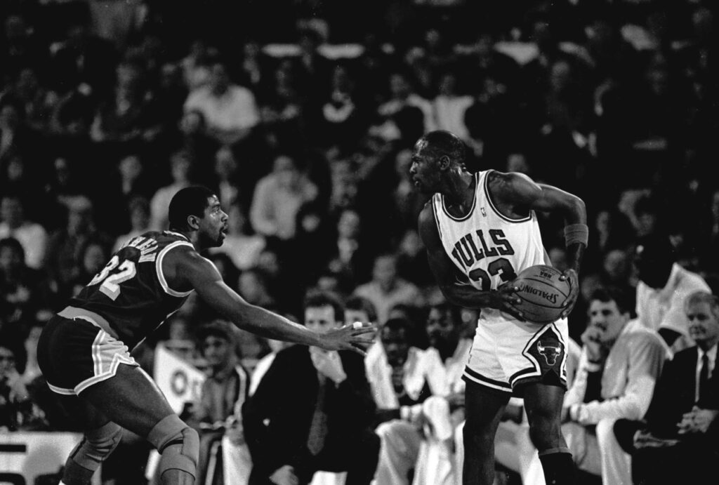 Clash of Legends: Michael Jordan vs. Magic Johnson at the Iconic 1988 Basketball Showdown Wallpaper