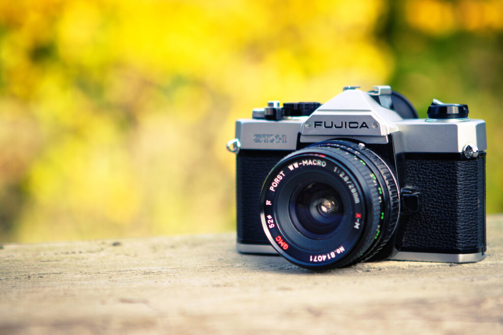 Vintage Fujica Camera Wallpaper with Sunny Yellow Background