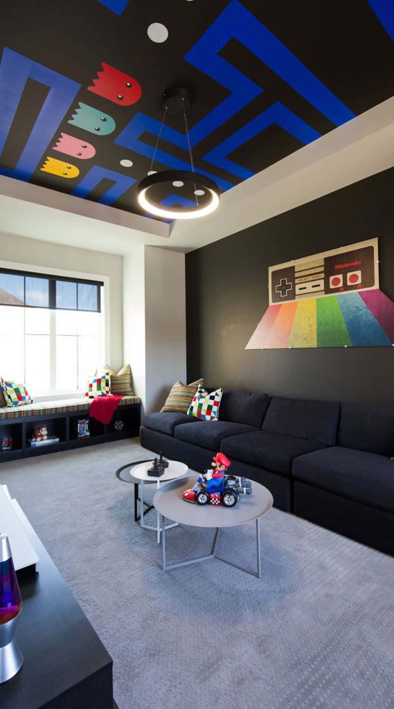 Retro gaming living room with Pac-Man ceiling mural Nintendo NES controller wall art and Mario Kart decor Wallpaper