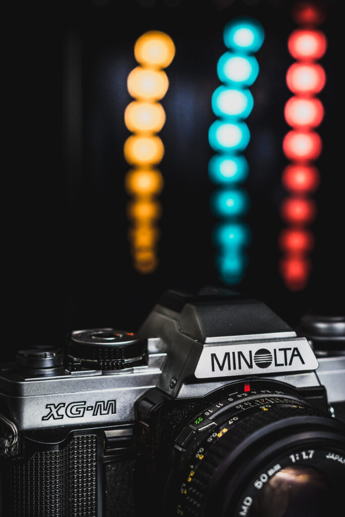 Retro Minolta XG-M Camera Wallpaper with Vibrant Bokeh Background