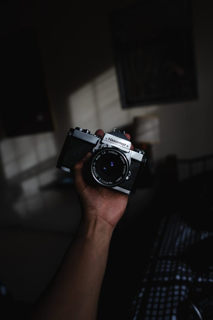 Vintage Nikkormat Camera Wallpaper: Retro Design with Dramatic Lighting