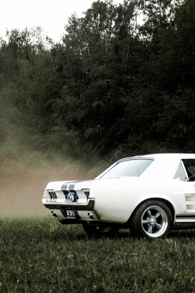 Retro Vintage Car Wallpaper: Drama & Nostalgia on Grass Background