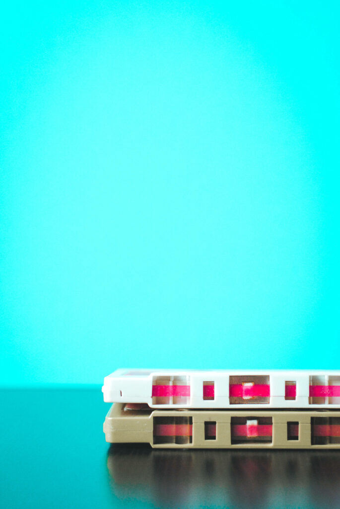 Nostalgic Vintage Cassette Tape Wallpaper on Bright Blue Background