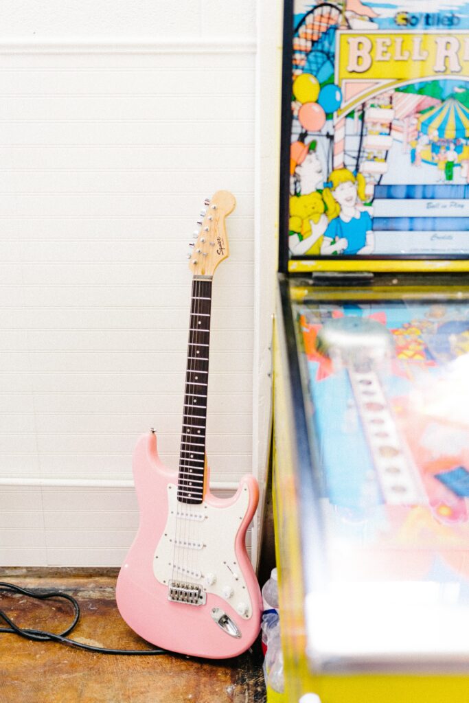 Retro Wallpaper: Pink Electric Guitar & Colorful Pinball Machine