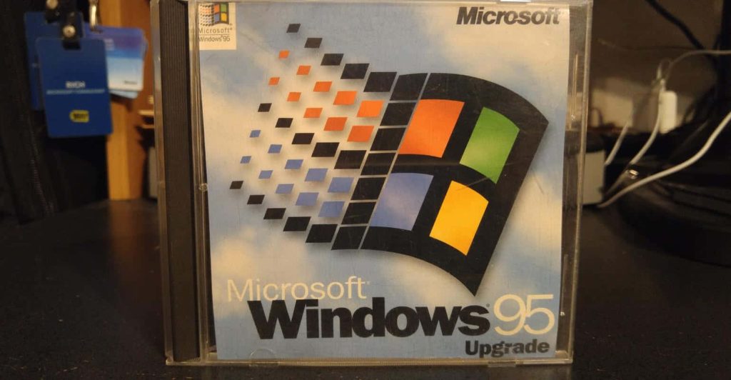 Microsoft Windows 95 Upgrade CD jewel case with iconic multicolor logo on blue background Wallpaper