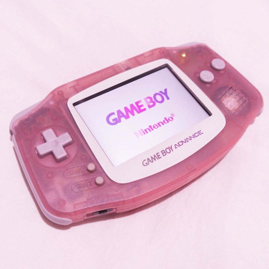 Translucent pink Game Boy Advance with Nintendo startup screen retro aesthetic wallpaper background