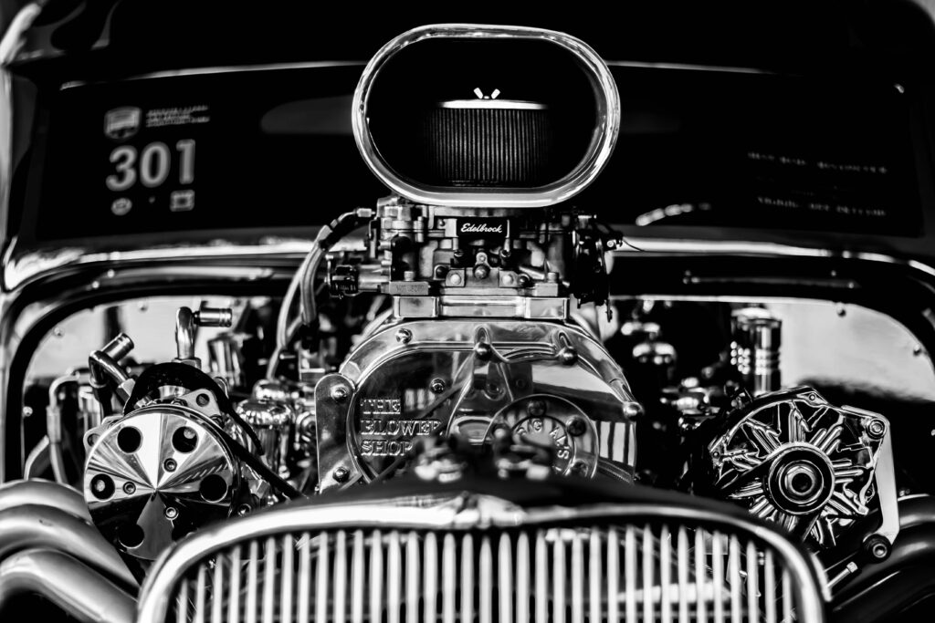 Vintage hot rod engine close-up with polished Blower Shop supercharger and Edelbrock parts Wallpaper