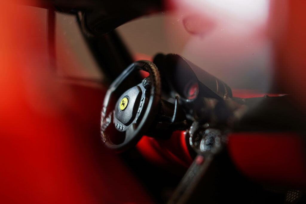 Embrace luxury and style with the mesmerizing red Ferrari interior - a stunning fusion of sleek sportsmanship and cutting-edge technology Wallpaper