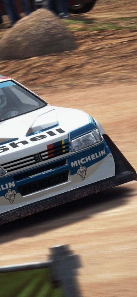 Intense Dirt Rally Car in Action with Sponsor Logos on Display Wallpaper