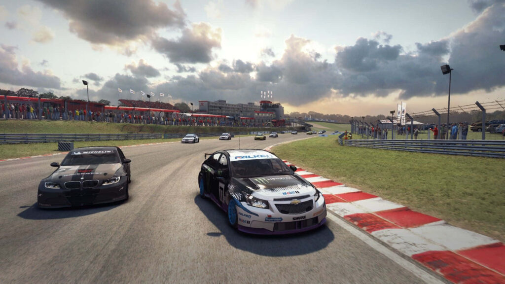 Dynamic Grid Autosport wallpaper with BMW and Chevrolet racing cars dueling on track, sun shining, and crowd in background