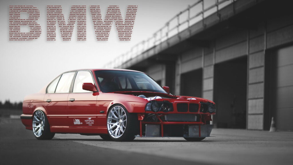 Red BMW 5 Series E34 drift car with aggressive front and sharp aftermarket wheels low angle Wallpaper