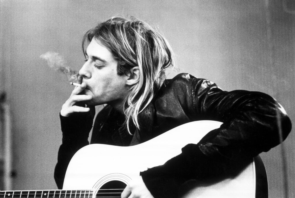 Legendary Nirvana Frontman: Kurt Cobain Rocking the Stage Wallpaper