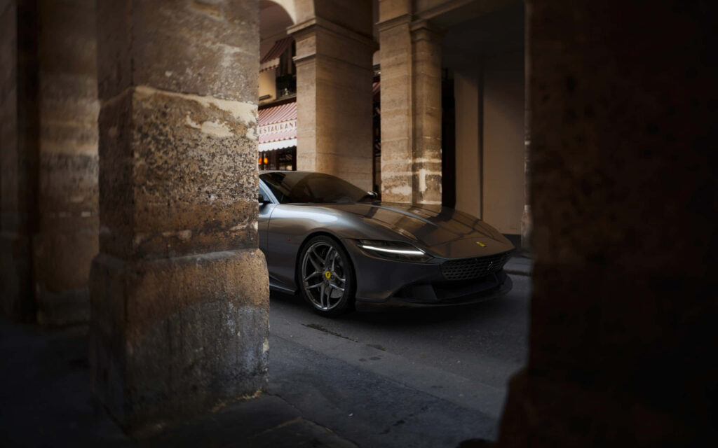 Sleek Power: Red Ferrari Roma Captivates on Scenic Highway Wallpaper