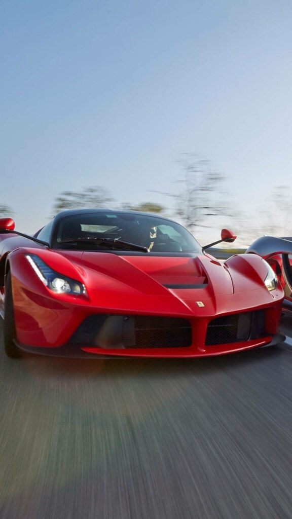 The Speed Demon: Thrilling race-ready Red La Ferrari tearing through a challenging road Wallpaper
