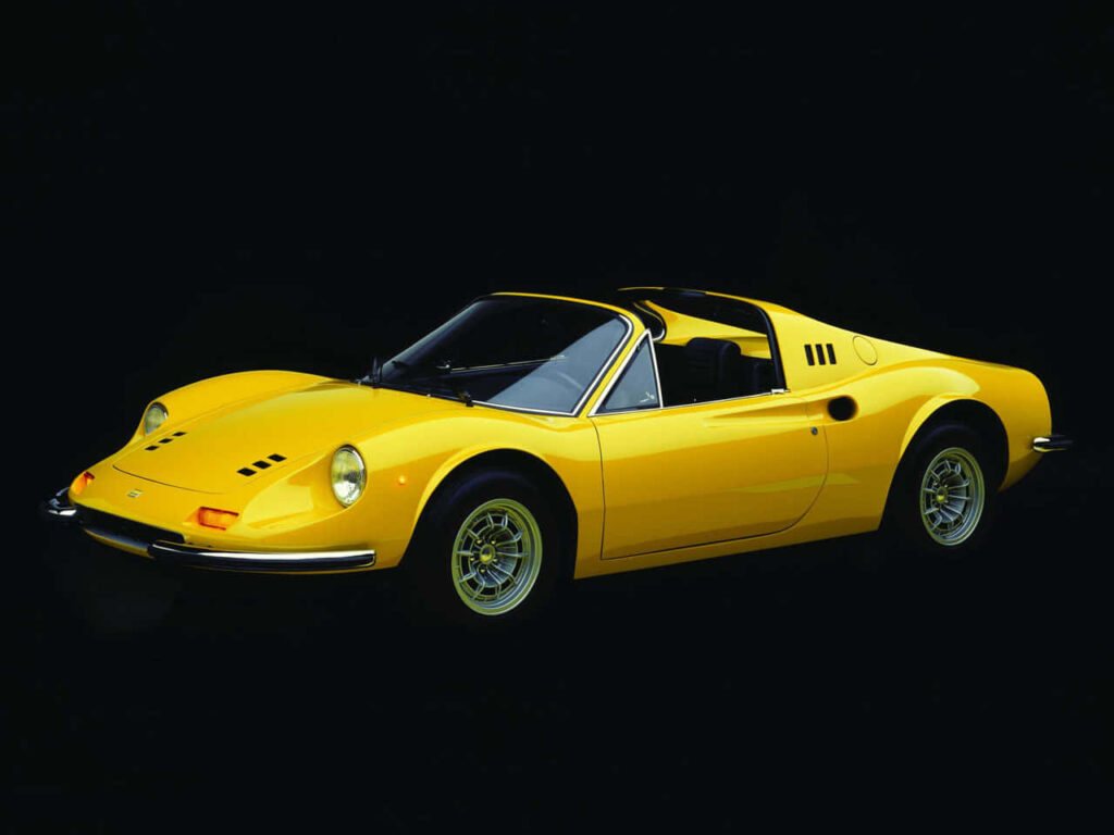 Yellow Ferrari Car against a Dark Black Background Wallpaper