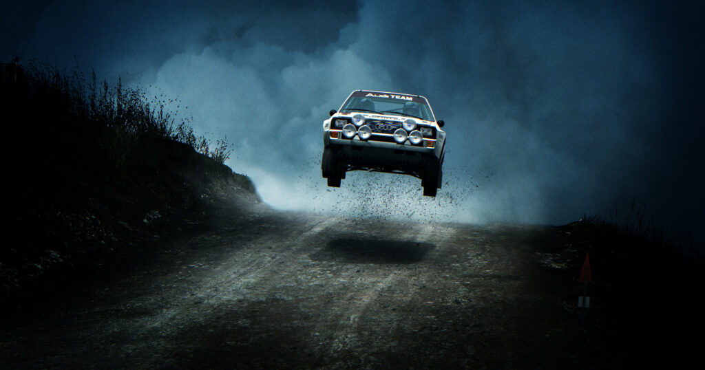Powerful rally car in mid-air over hill with dust and headlights Wallpaper