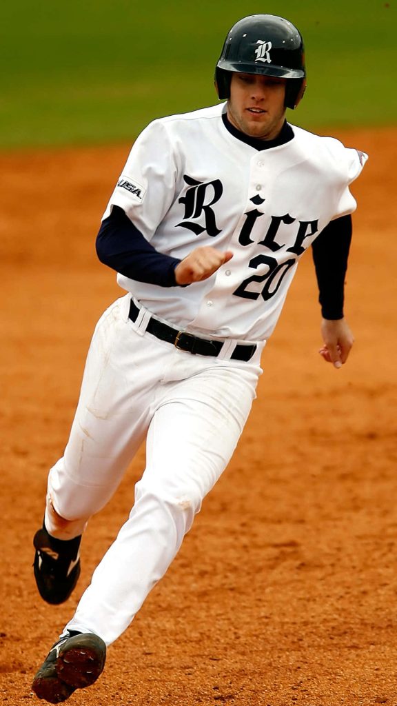 Rice University Owls baseball player number 20 sprinting intensely in white uniform on field Wallpaper