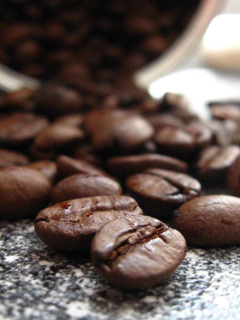 Macro Close-Up of Rich Brown Coffee Beans - Textured Wallpaper Background