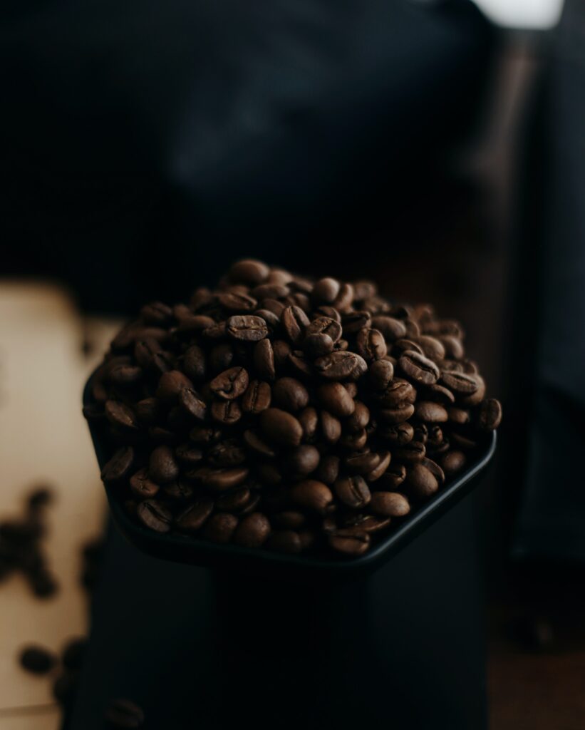 Rich Dark Coffee Beans in Ceramic: Warm Aromatic Wallpaper Background