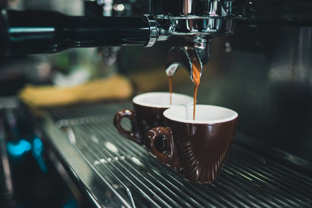 Espresso Pouring Into Ceramic Cups - Warm Coffee Wallpaper