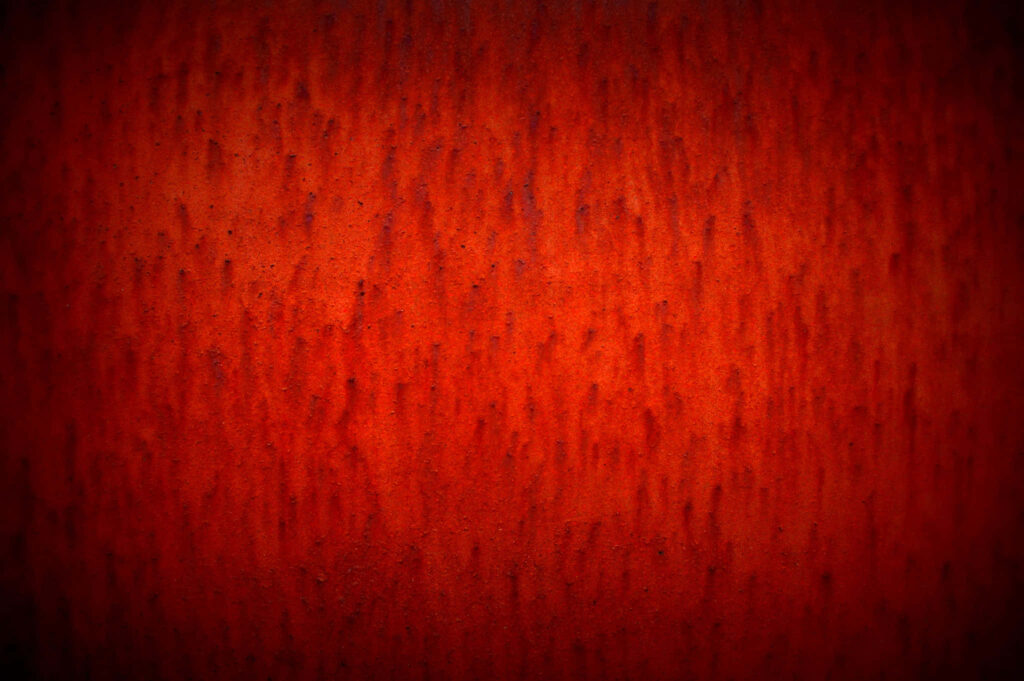 Rich Red Textured Wallpaper with Warm Subtle Vignette Effect