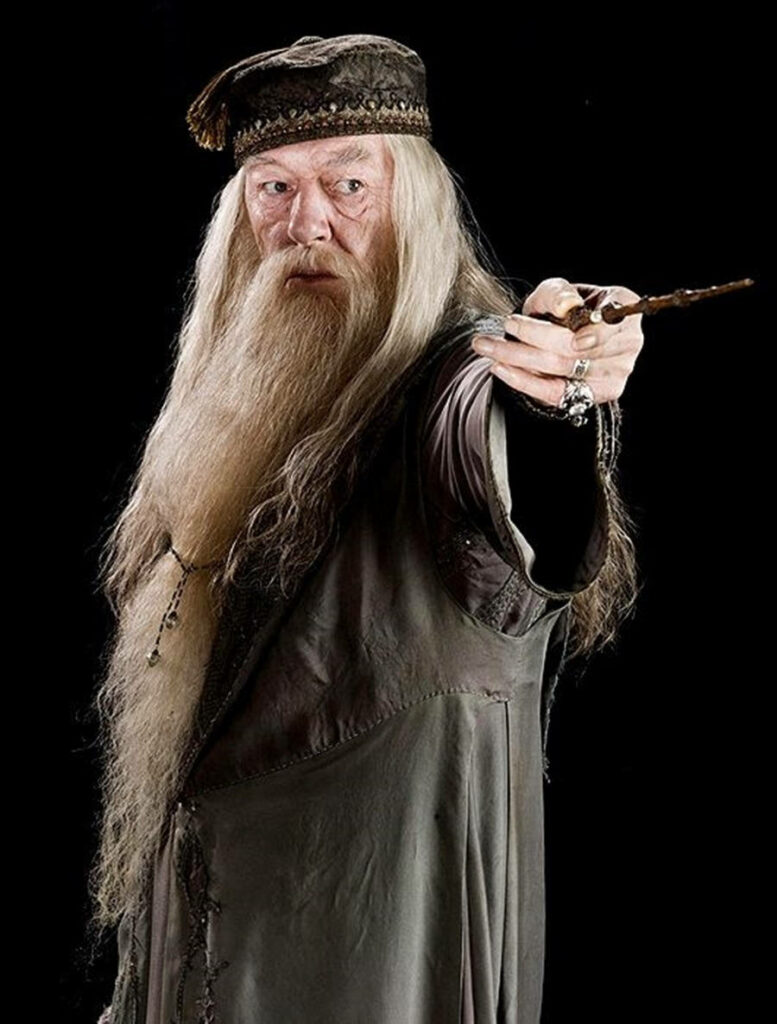 Irish actor Richard Harris as Professor Dumbledore in wizard robes holding a wand photoshoot Wallpaper