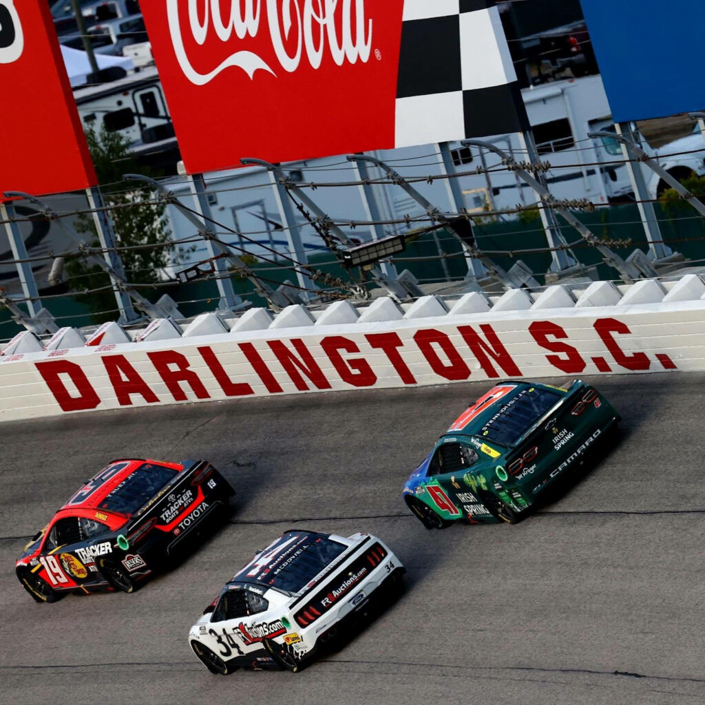Ricky Stenhouse Jr racing side by side on Darlington South Carolina track intense NASCAR action Wallpaper