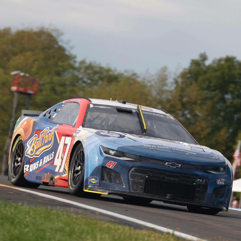 Ricky Stenhouse Jr No 47 race car speeding on track vibrant colors race day intensity wallpaper