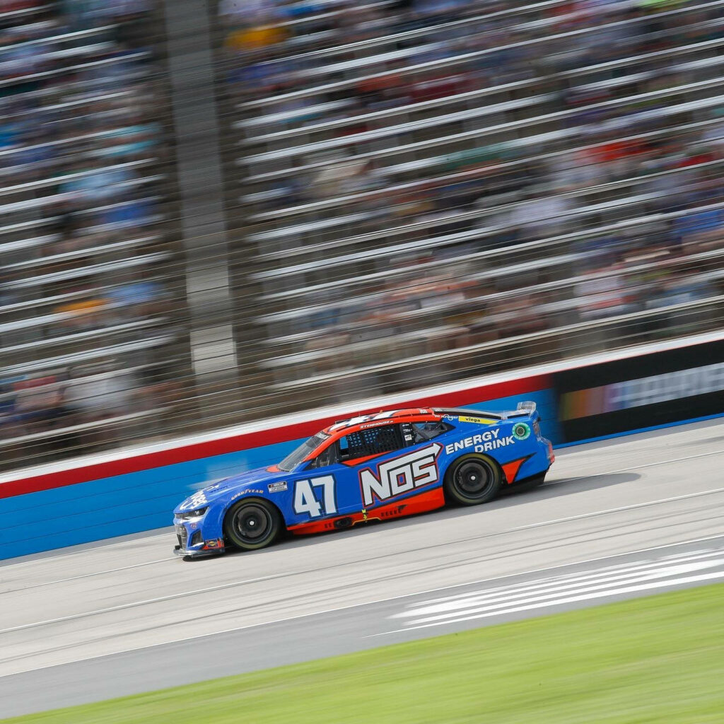 Ricky Stenhouse Jr No 47 NOS Energy race car speeding with motion blur on racetrack wallpaper