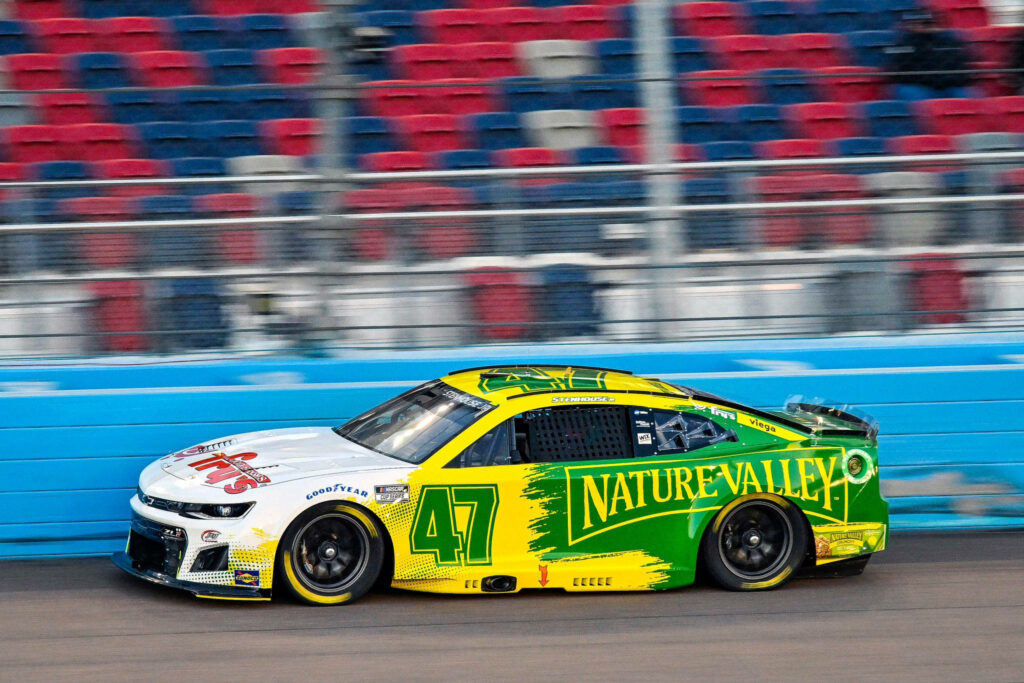 Ricky Stenhouse Jr No 47 Nature Valley yellow green race car speeding on racetrack wallpaper