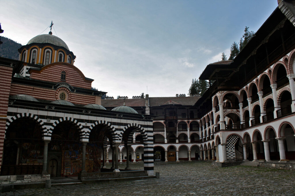 Rila Monastery in Bulgaria surrounded by scenic mountains historic architecture wallpaper background