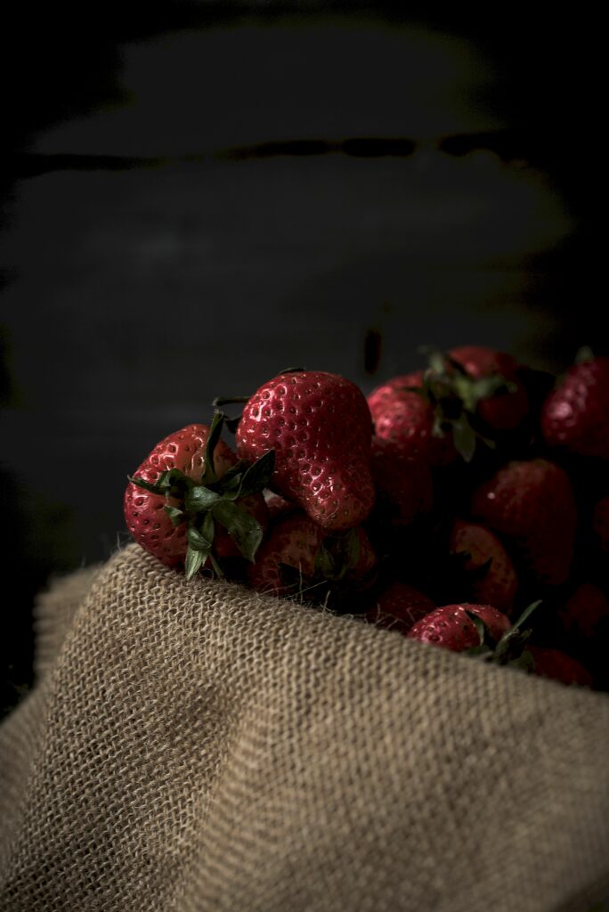 Ripe Strawberries on Textured Cloth: Soft Light Wallpaper Background