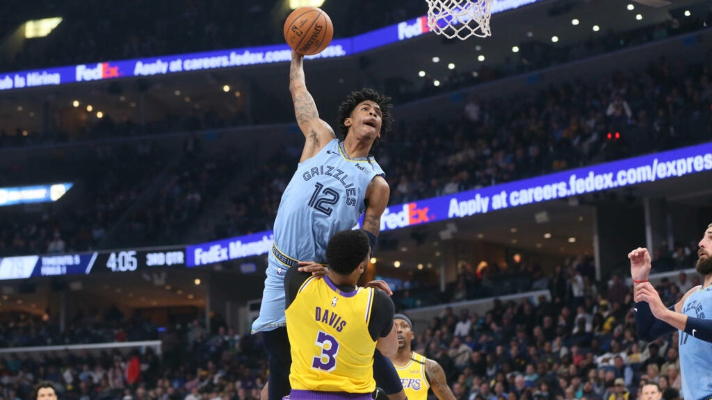 Gravity-Defying Ja Morant Slam Poster featuring Morant Skying Over Lakers' Anthony Davis Wallpaper