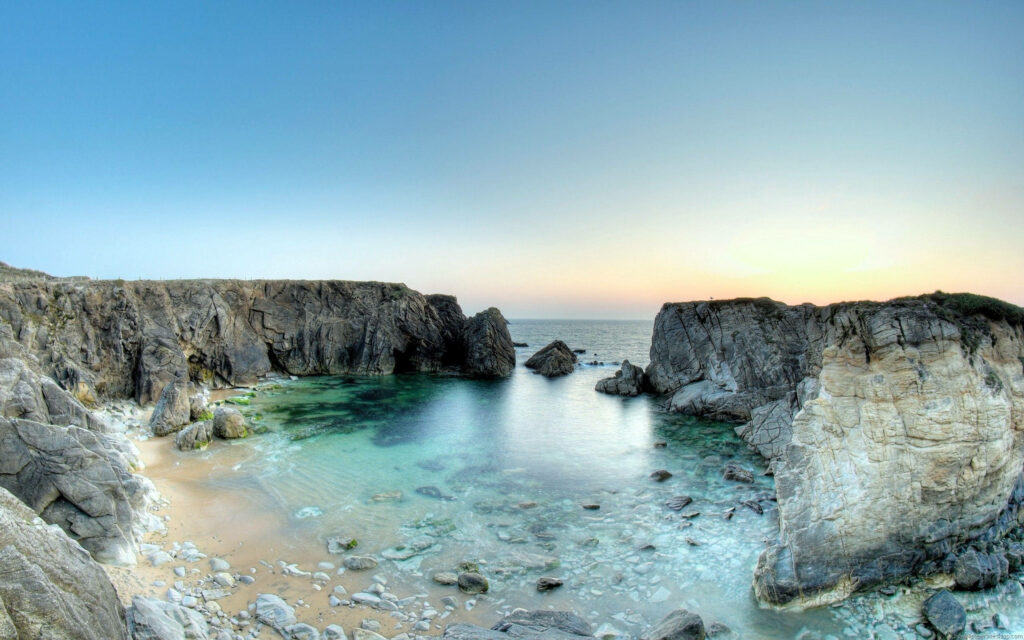 Sunrise Serenity: A Stunning High Resolution Rocky Seaside Landscape Wallpaper