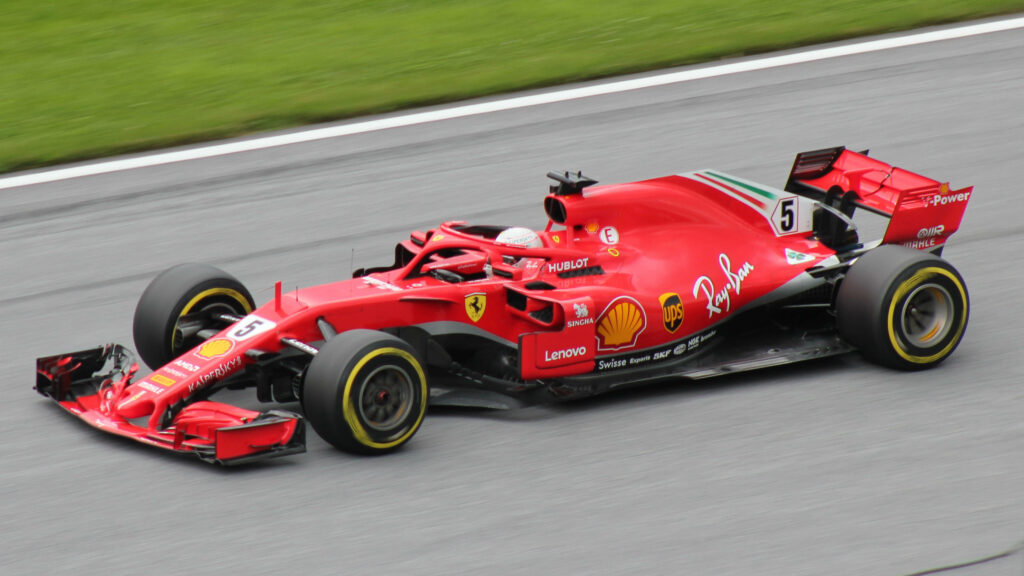 Roaring through the Tracks: Ferrari's Dominance in the F1 2018 Season - Captivating Background Snapshot Wallpaper