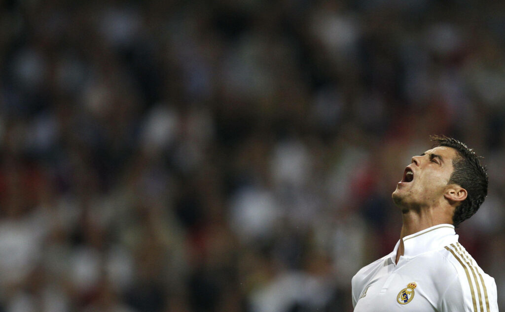 Roaring Triumph: Cristiano Ronaldo's Electrifying Celebration Wallpaper