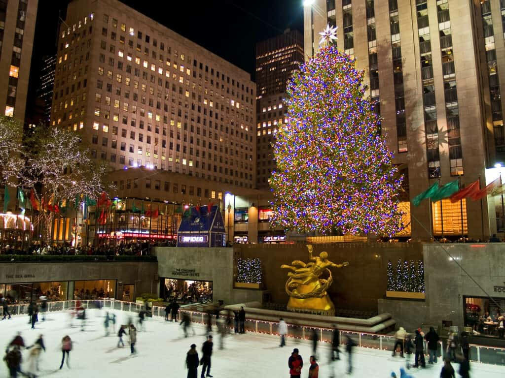 Festive Ice Skating at Rockefeller Center Under the Christmas Tree Wallpaper