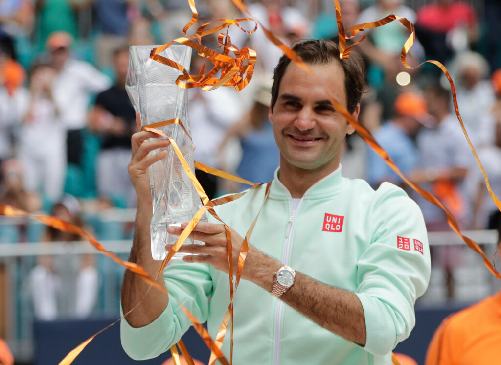Roger Federer Celebrates Victory with Crystal Trophy - Vibrant Wallpaper