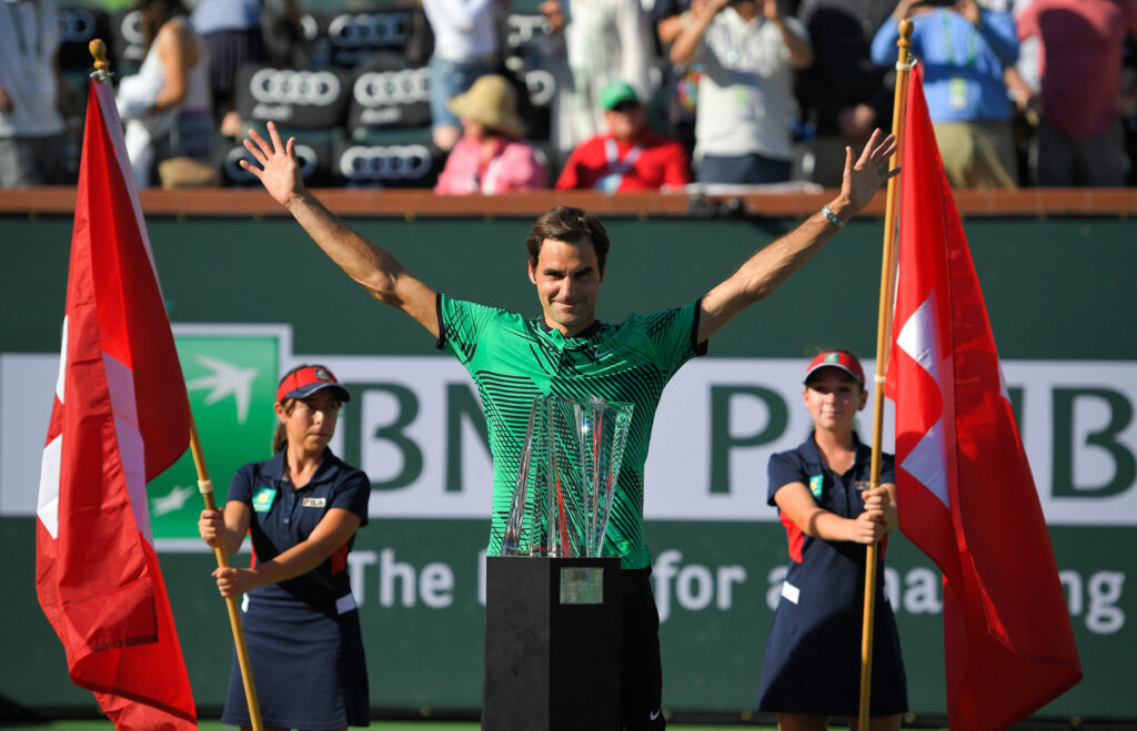 Roger Federer Celebrates Victory with Trophy & Flags - Stunning Wallpaper