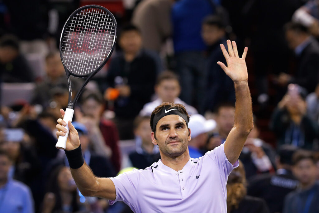 Roger Federer Celebrates with High Five - Vibrant Tennis Wallpaper