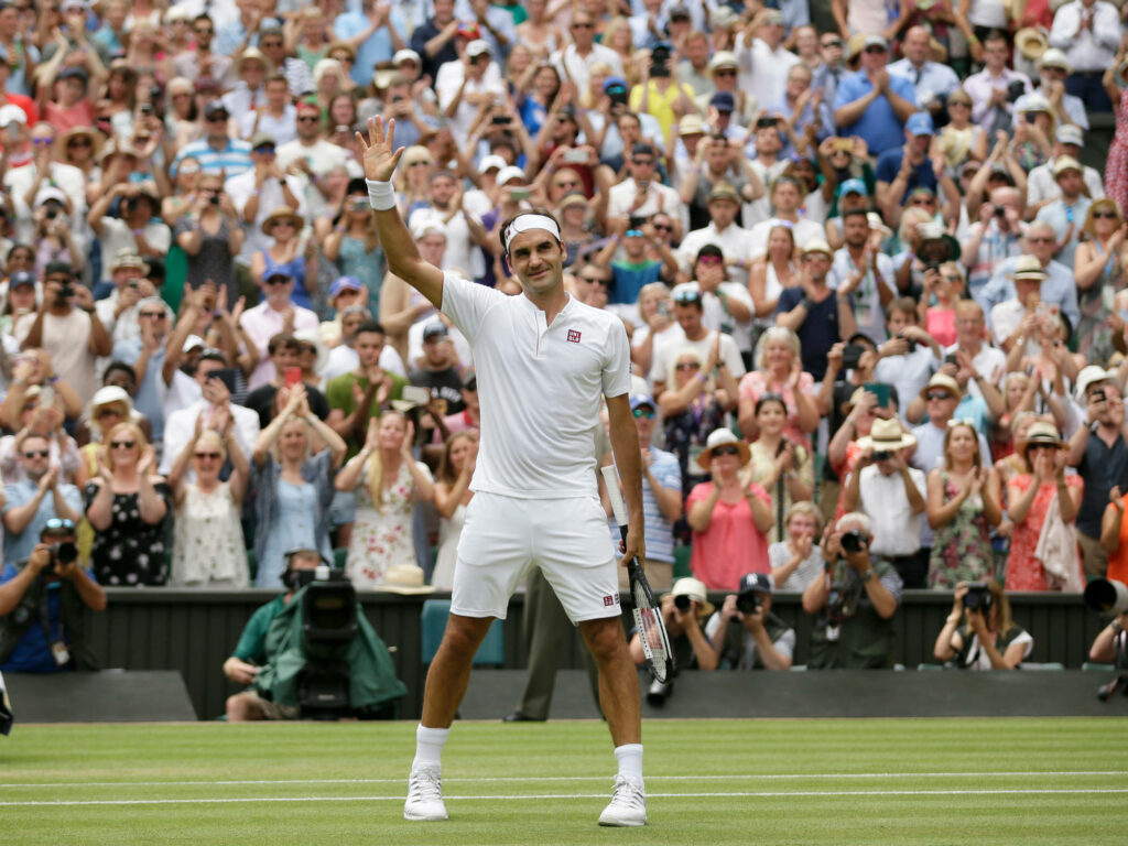 Roger Federer Waving to Fans on Tennis Court - Celebratory Wallpaper