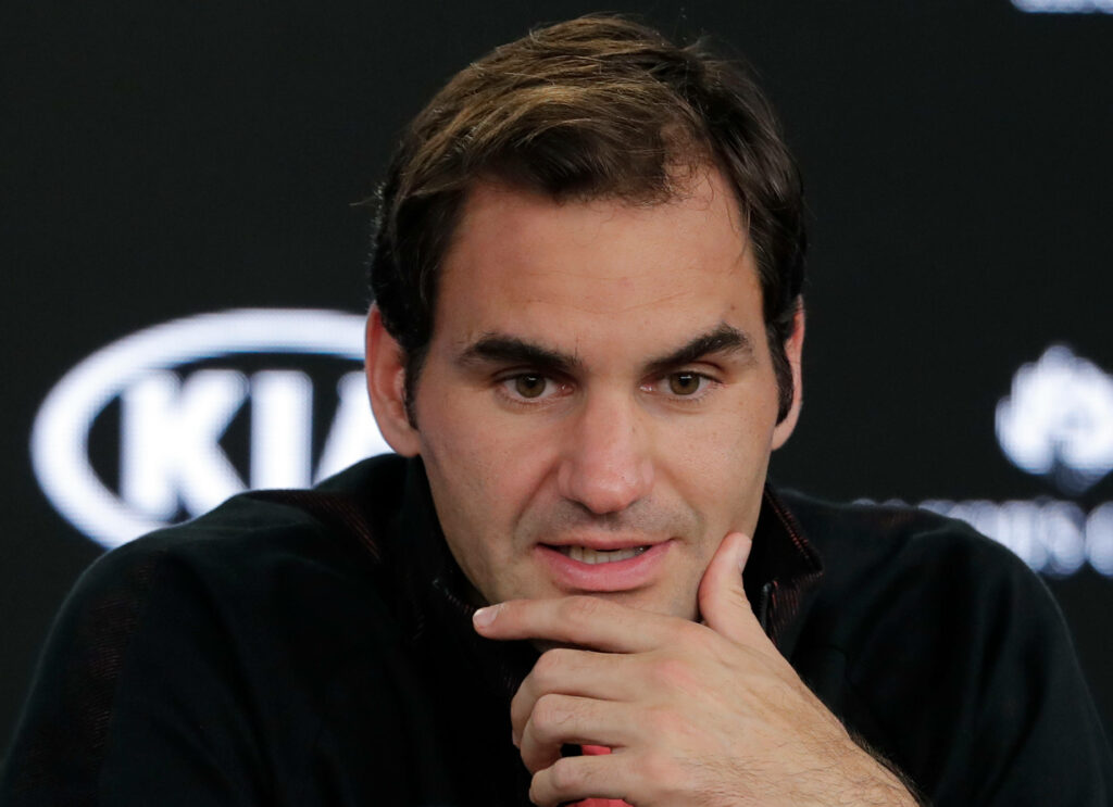 Roger Federer Wallpaper: Thoughtful Tennis Legend Interview Background