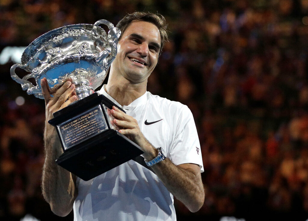 Roger Federer Wallpaper: Celebrating Victory with Championship Trophy